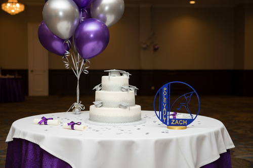 Graduation party cake table purple and silver with javelin award